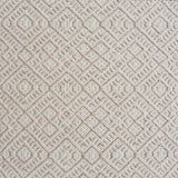 Flatweave rug with an intricate diamond pattern in white and beige. 