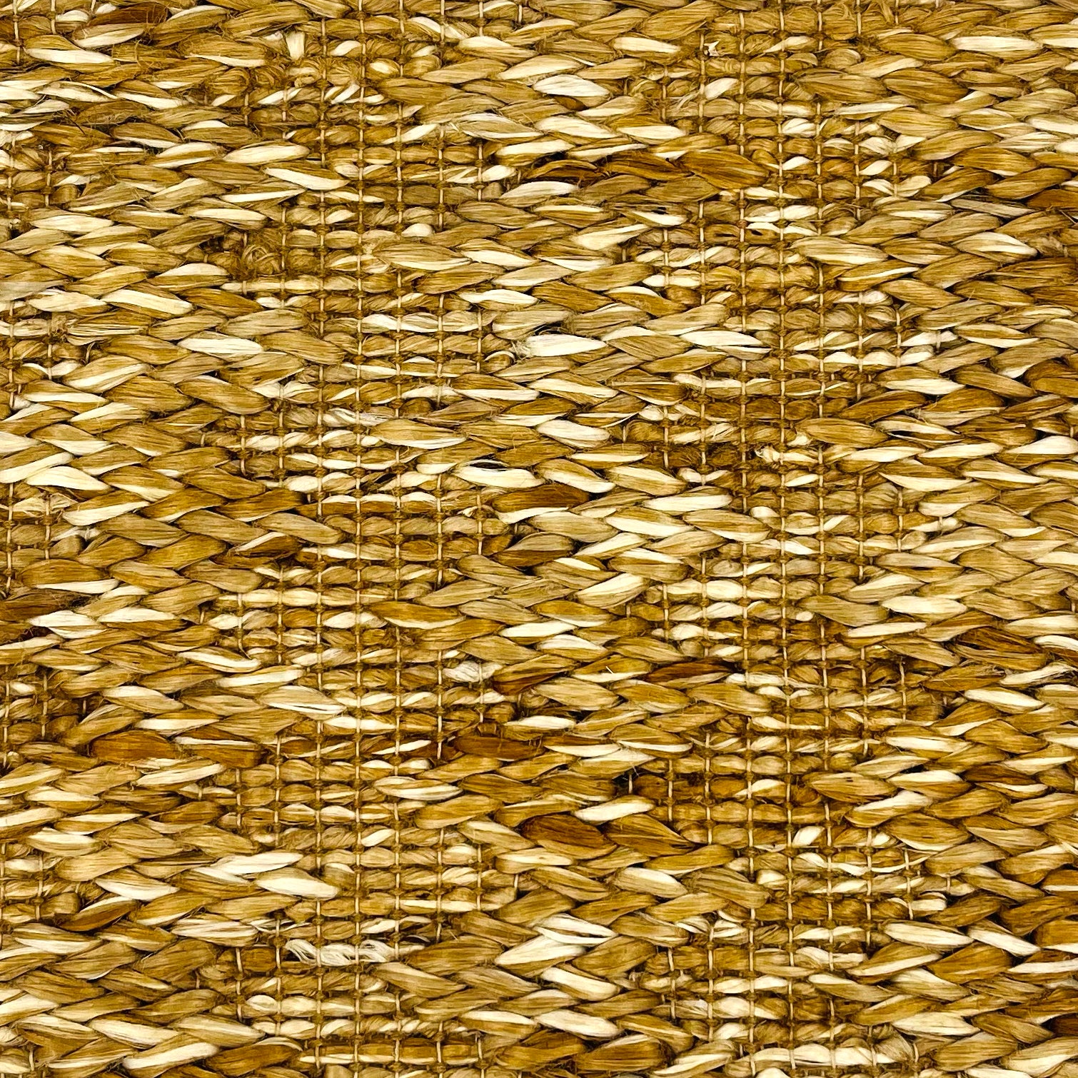 Woven rug swatch in natural fibers in a subtle striated stripe pattern