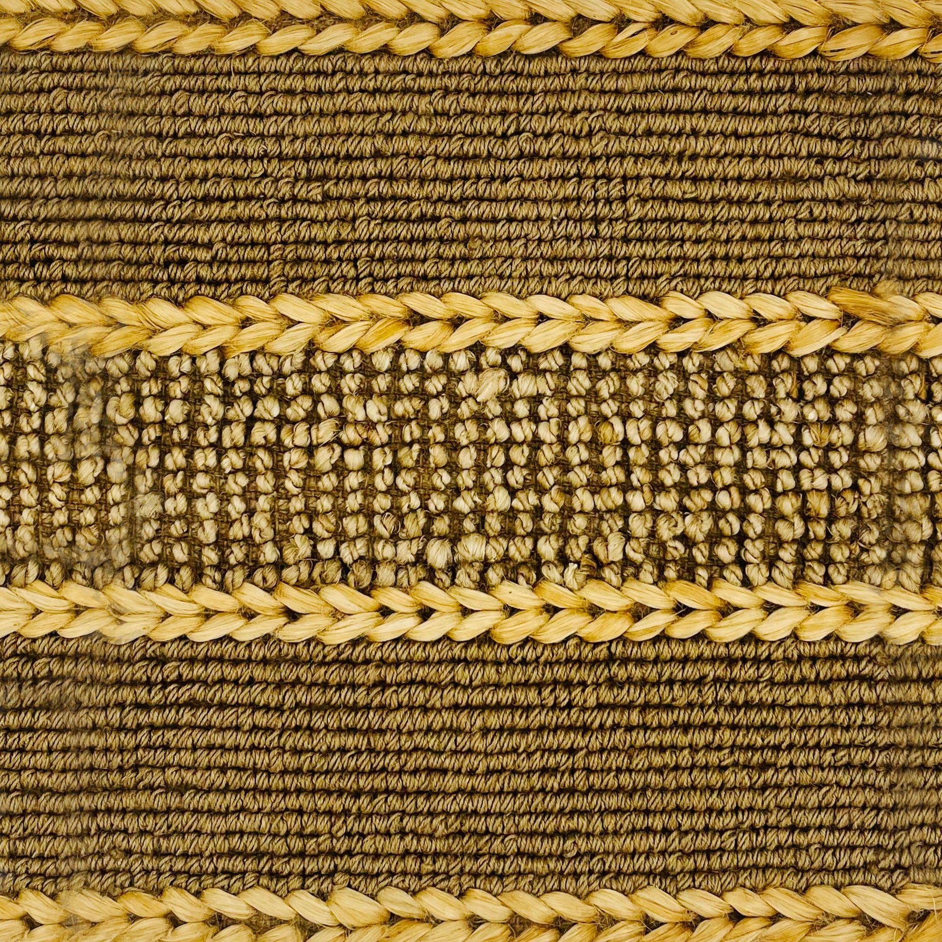 Woven rug swatch in natural fibers in a woven stripe pattern in natural tan.