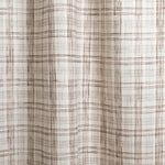 Draped fabric with watercolor plaid pattern in shades of dark brown.