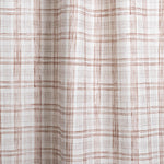 Draped fabric with watercolor plaid pattern in shades of brick red. 
