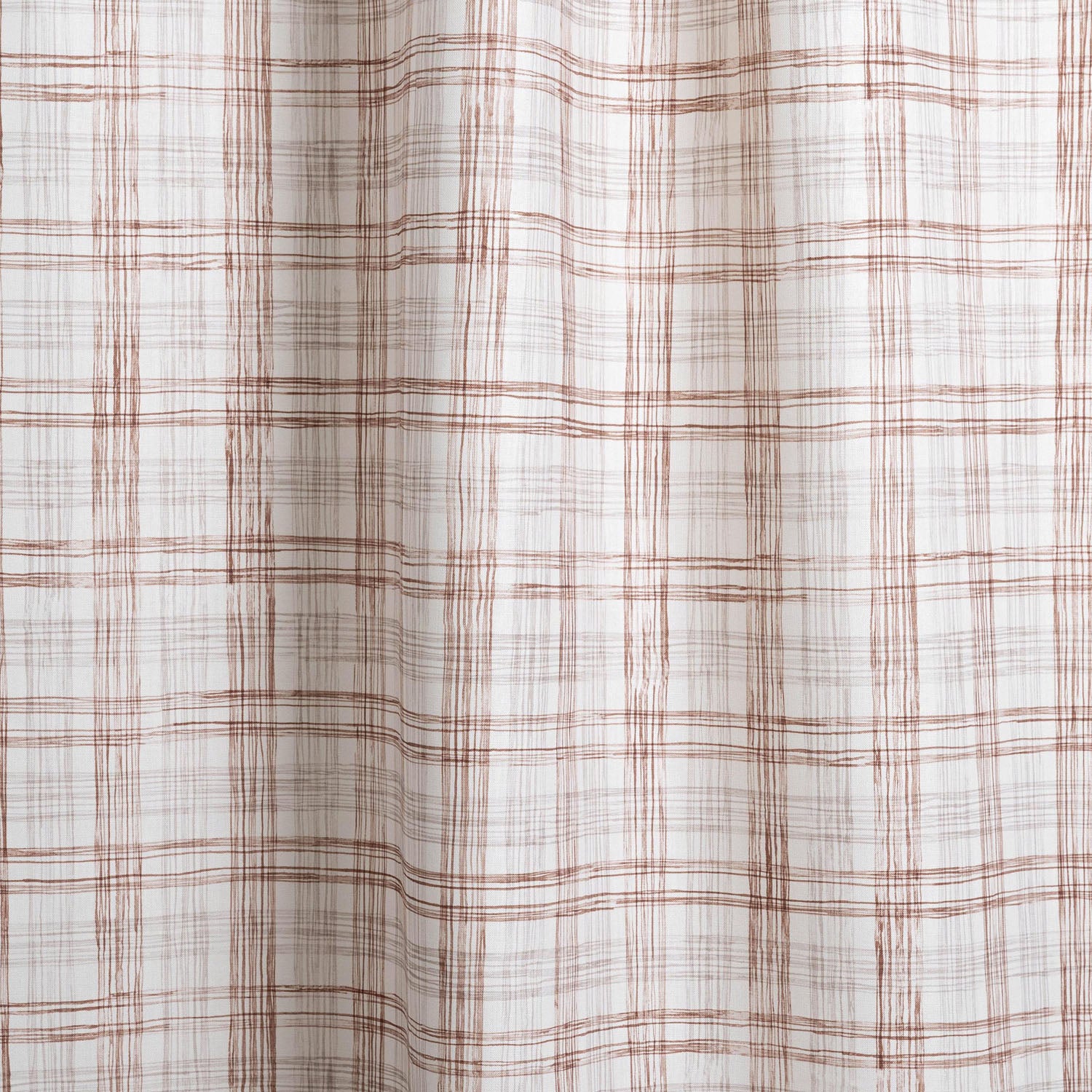 Draped fabric with watercolor plaid pattern in shades of brick red. 