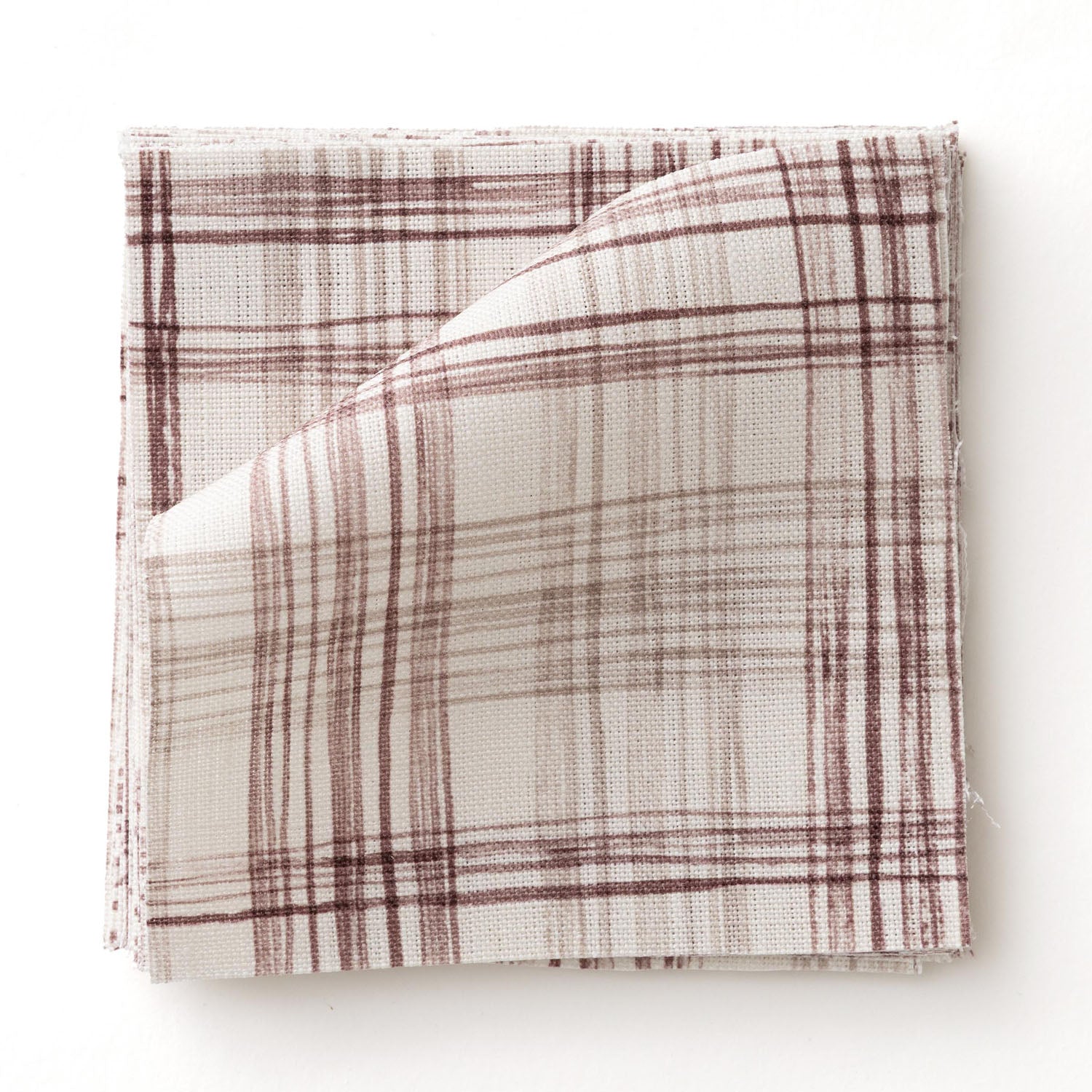 Fabric swatch with watercolor plaid pattern in shades of wine red.