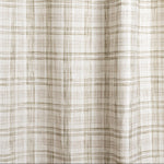 Draped fabric with watercolor plaid pattern in shades of olive green.