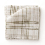 Fabric swatch with watercolor plaid pattern in shades of olive brown.