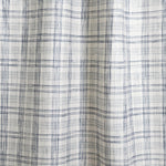 Draped fabric with watercolor plaid pattern in shades of blue. 