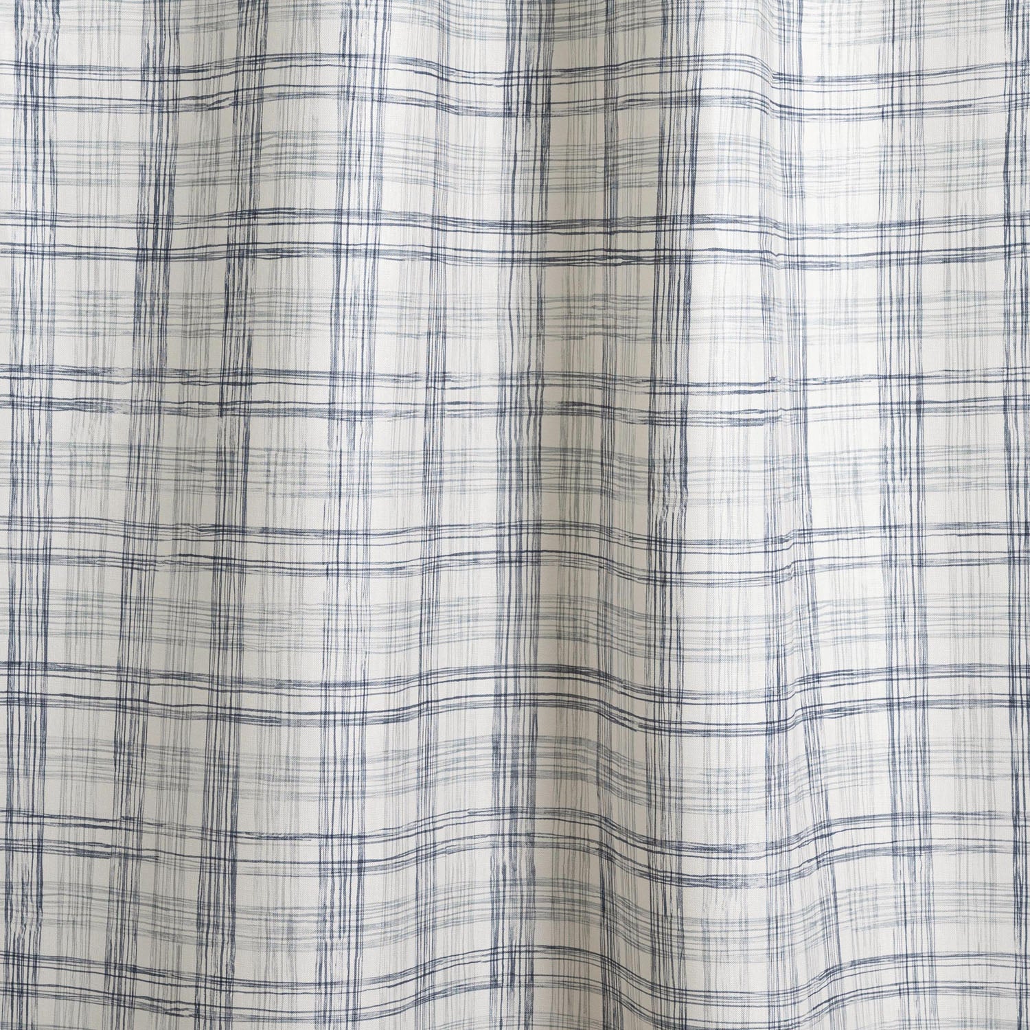 Draped fabric with watercolor plaid pattern in shades of blue. 