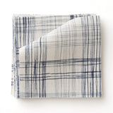 Fabric swatch with watercolor plaid pattern in shades of blue. 