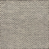 Textured rug with a herringbone pattern in white and charcoal grey