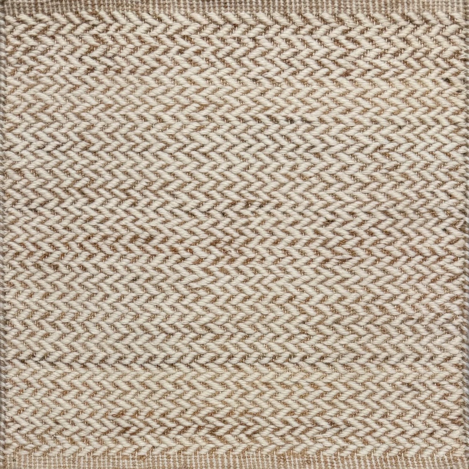 Textured rug with a herringbone pattern in white and tan.