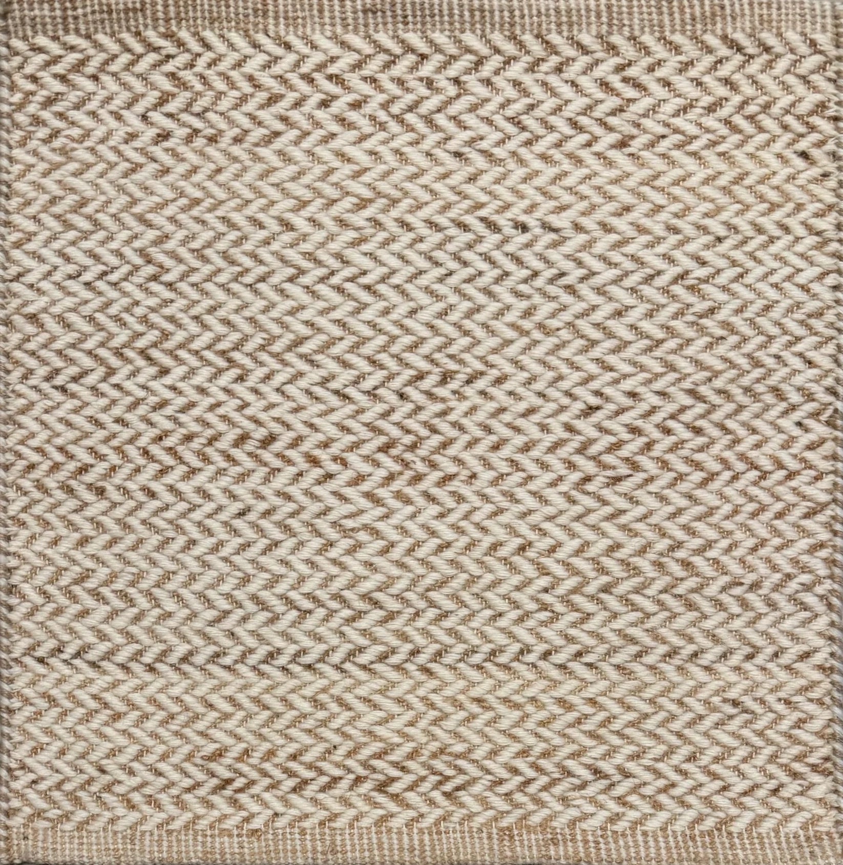 Textured rug with a herringbone pattern in white and tan.