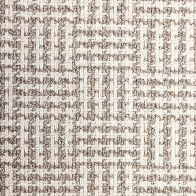 Broadloom carpet with houndstooth check pattern in cream and light brown. 