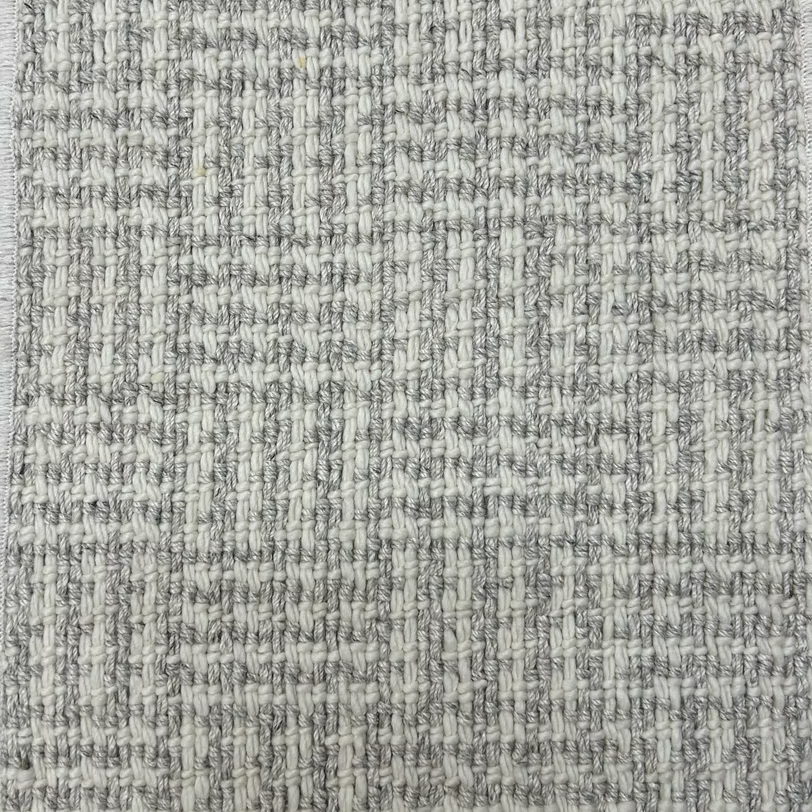 Broadloom carpet with houndstooth check pattern in cream and light grey.
