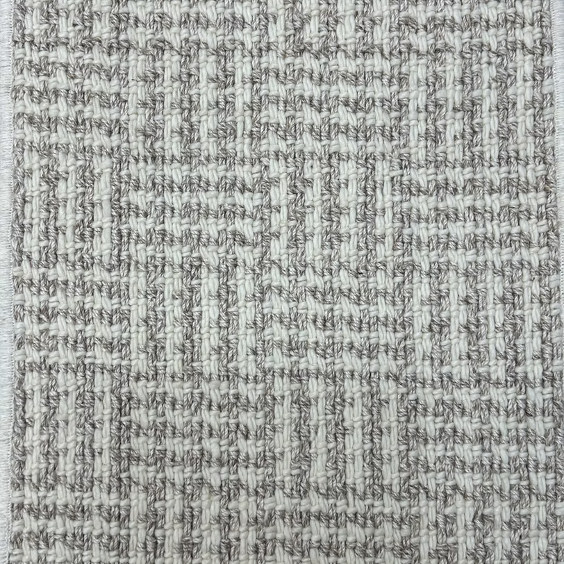 Broadloom carpet with houndstooth check pattern in cream and grey.
