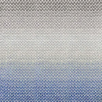 Broadloom carpet in a herringbone pattern in a subtle ombré color from bright blue to soft grey.