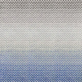 Broadloom carpet in a herringbone pattern in a subtle ombré color from bright blue to soft grey.