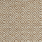 Detail of handwoven rug with diamond pattern in cream and shades of brown. 