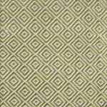 Detail of handwoven rug with diamond pattern in cream and lime green. 