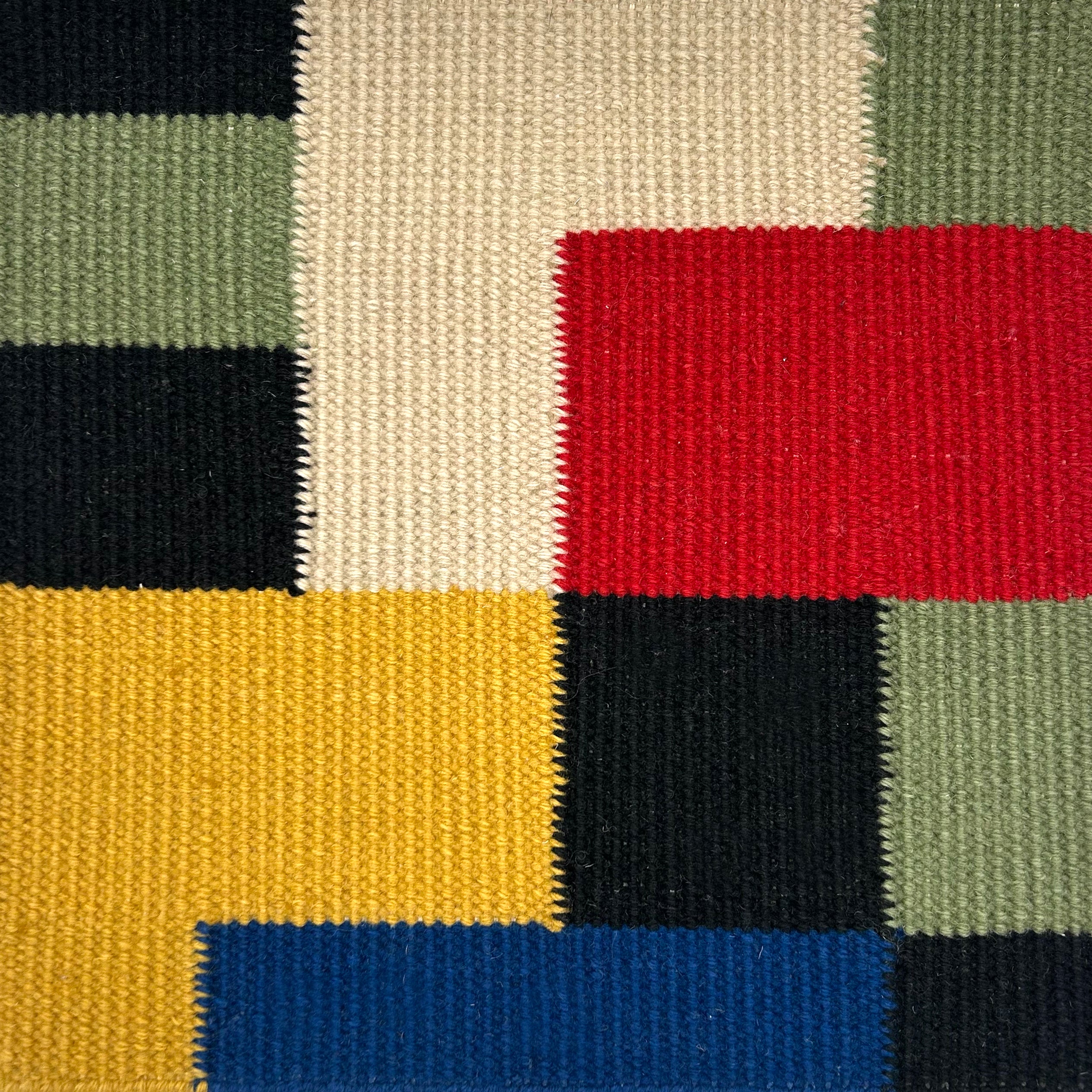 Colorful geometric pattern with squares in black, white, red, yellow, green and blue. 