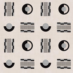 Graphic geometric pattern of circles, and stripes in black and grey on a cream field.