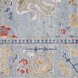 Decorative rug with floral and geometric patterns in blue, beige, and red on a light background