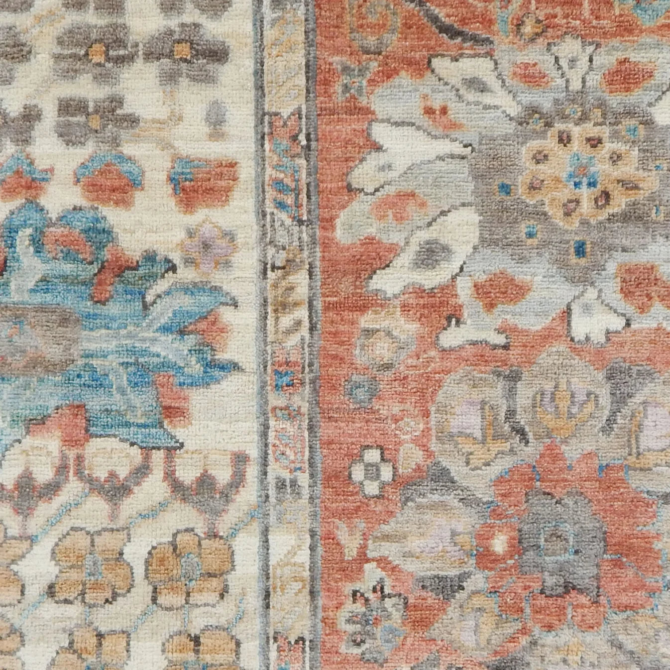 Close-up of a floral patterned rug with a blend of colors.