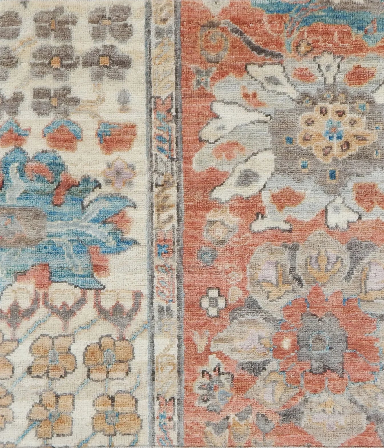 Close-up of a floral patterned rug with a blend of colors.