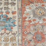 Close-up of a floral patterned rug with a blend of colors.