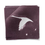 Fabric swatches in a flying geese and star pattern in white on a deep eggplant purple watercolor field.