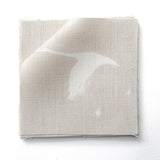 Stack of fabric swatches in a flying geese and star pattern in white on a pale ecru watercolor field.