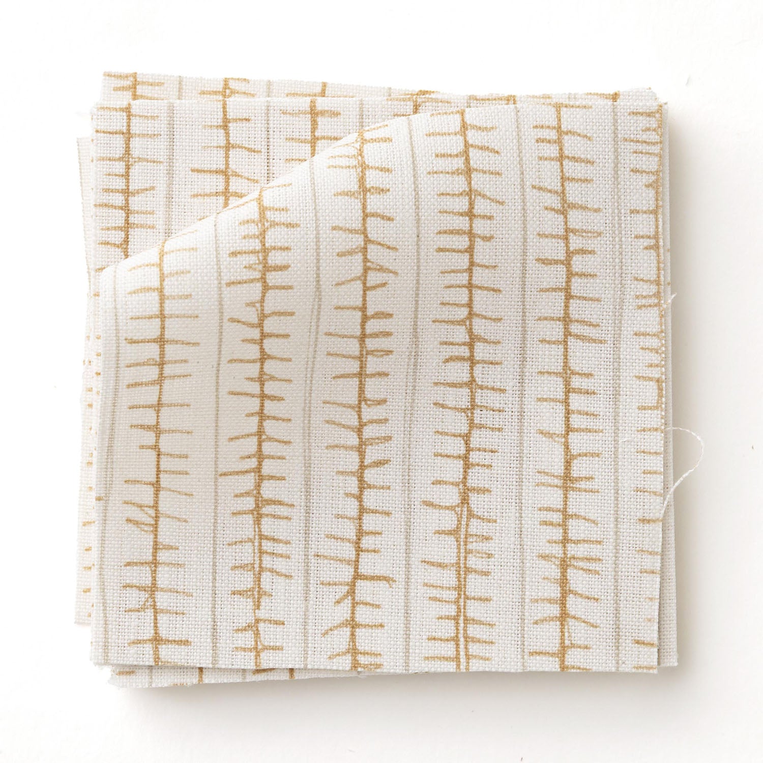 Swatch of fabric with hand drawn ticking stripe in caramel and grey on white.