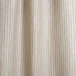 Draped fabric with hand drawn ticking stripe in black and taupe on white.