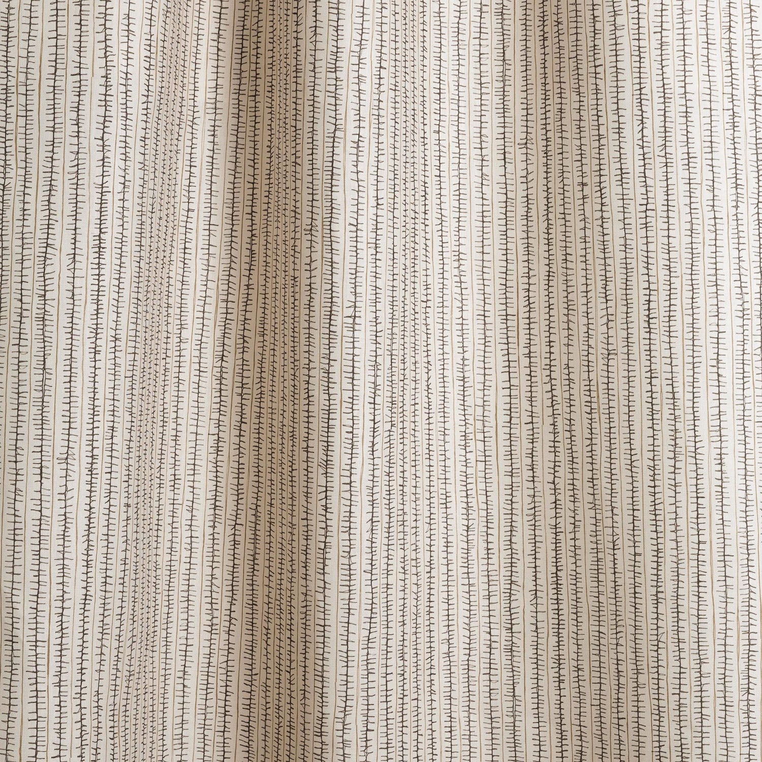 Draped fabric with hand drawn ticking stripe in black and taupe on white.
