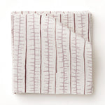 Swatch of fabric with hand drawn ticking stripe in shades of purple on white.