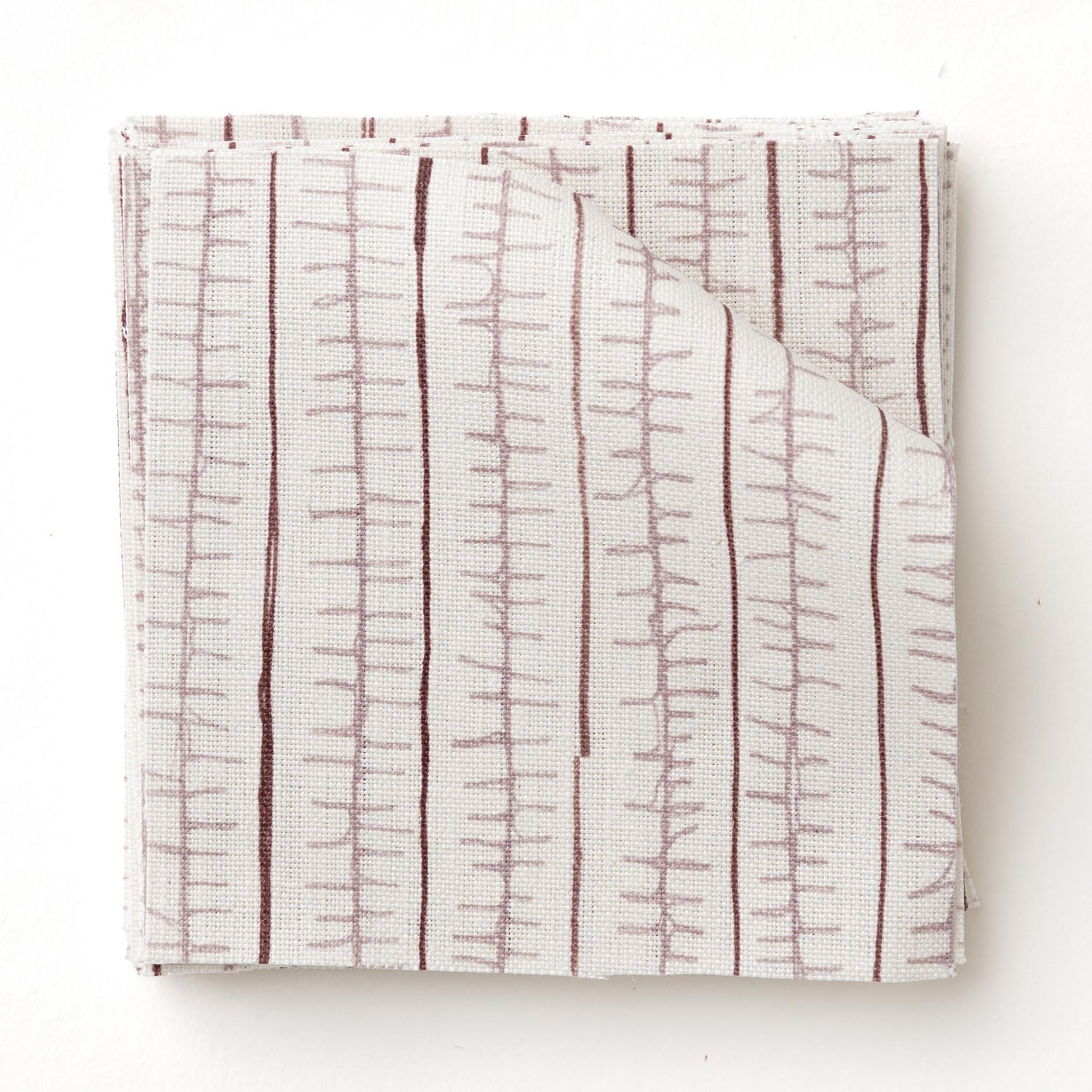 Swatch of fabric with hand drawn ticking stripe in shades of purple on white.