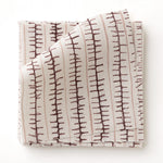 Swatch of fabric with hand drawn ticking stripe in wine purple and pink on white.