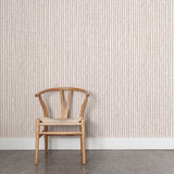Wooden chair against wallpaper with hand drawn ticking stripe in dark purple and tan on white. 