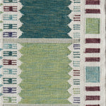 Handwoven rug detail in a Swedish checkerboard design shades of green and teal with white and brown accents. 