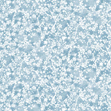 Painterly branch print in white on soft blue watercolor field.