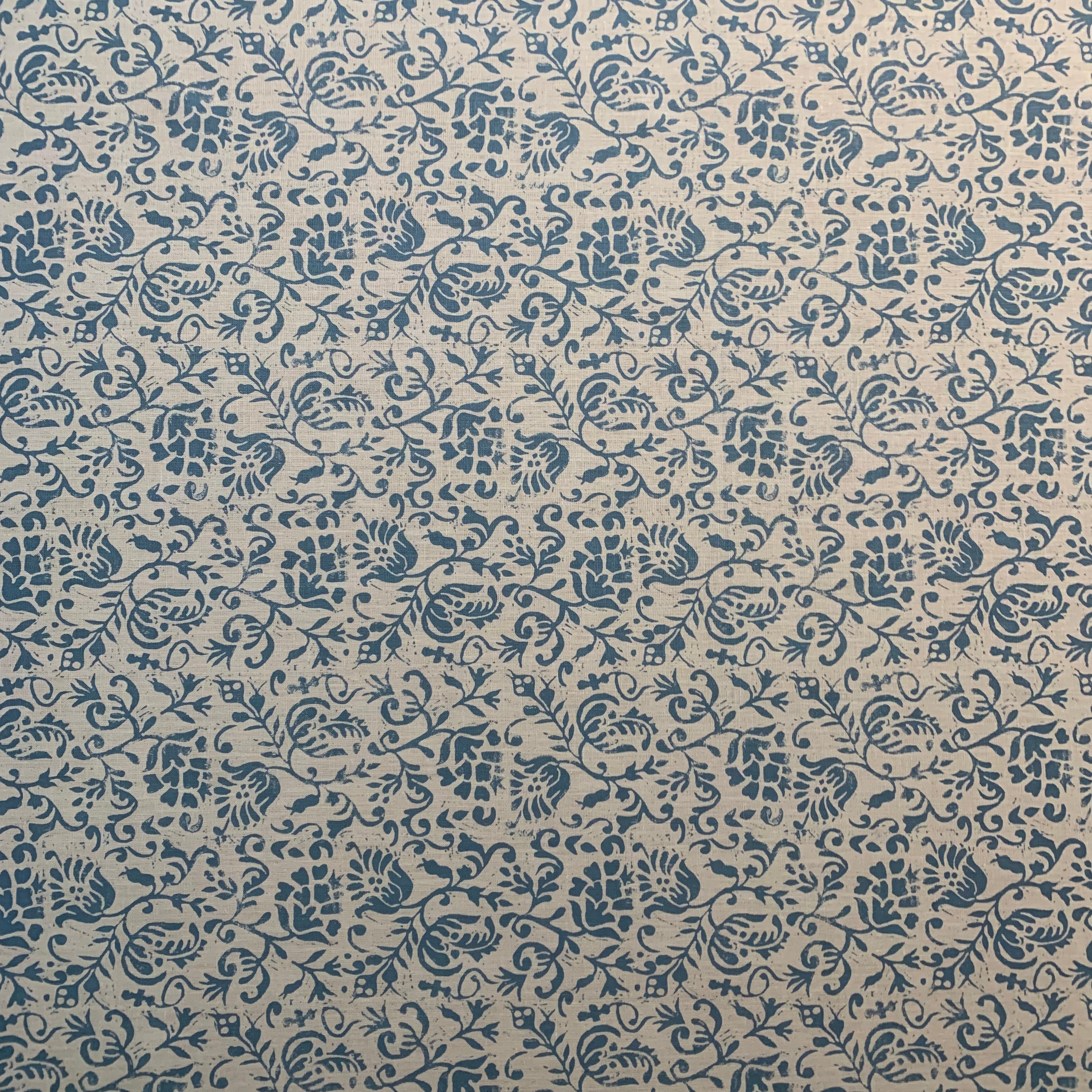Textured fabric with blue floral pattern on beige background
