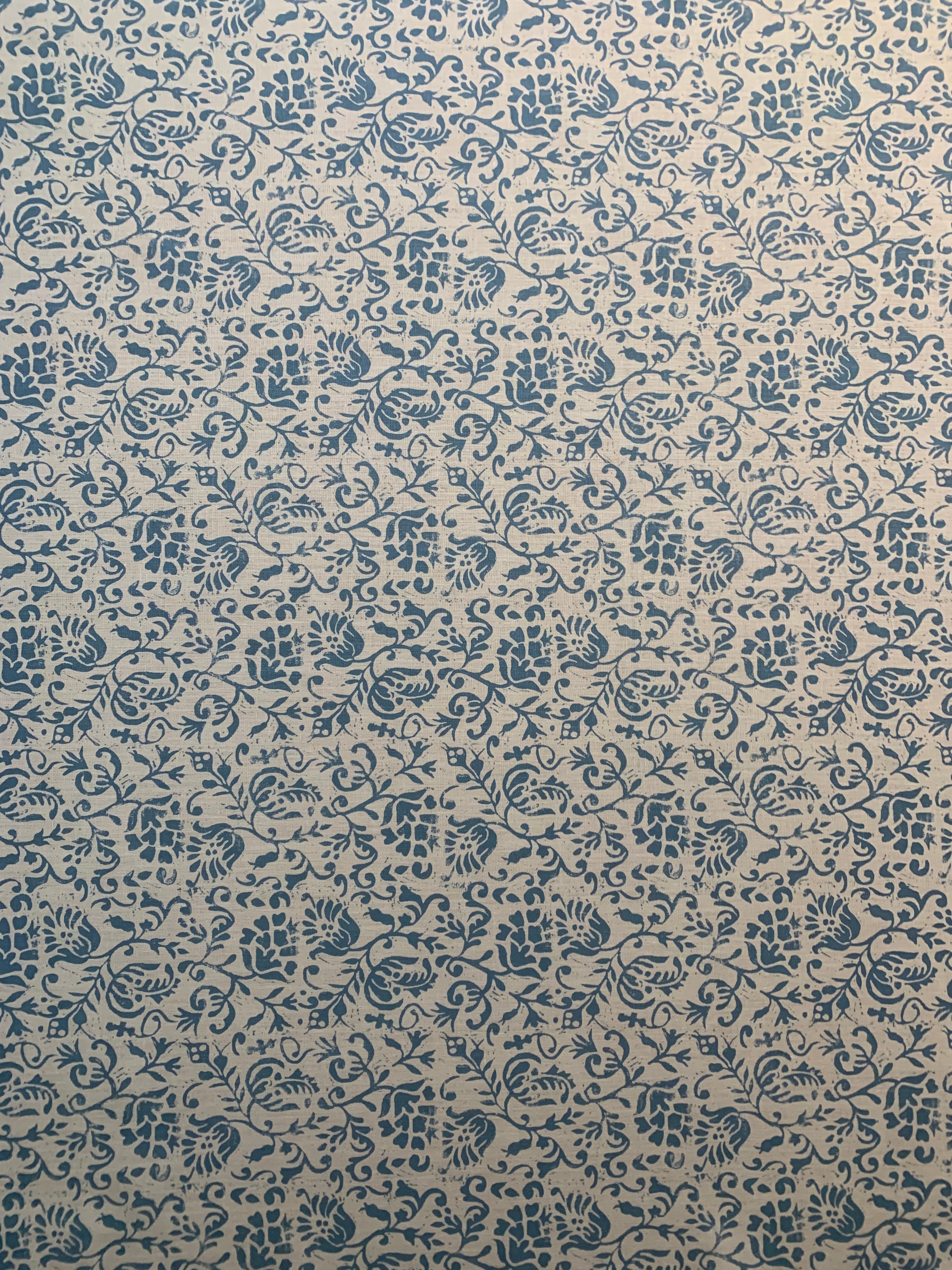 Textured fabric with blue floral pattern on beige background