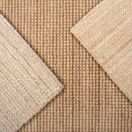 Close up of broadloom carpet samples in neutral colors. 