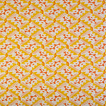 Detail of fabric in painterly diamond print in yellow and orange on a white field.
