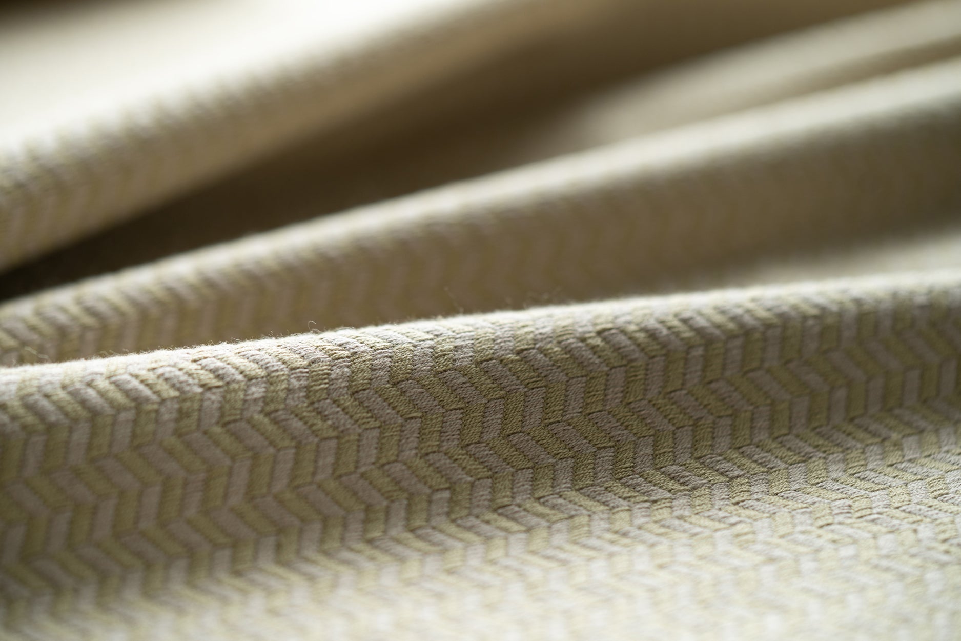Close-up of textured beige fabric with a subtle pattern