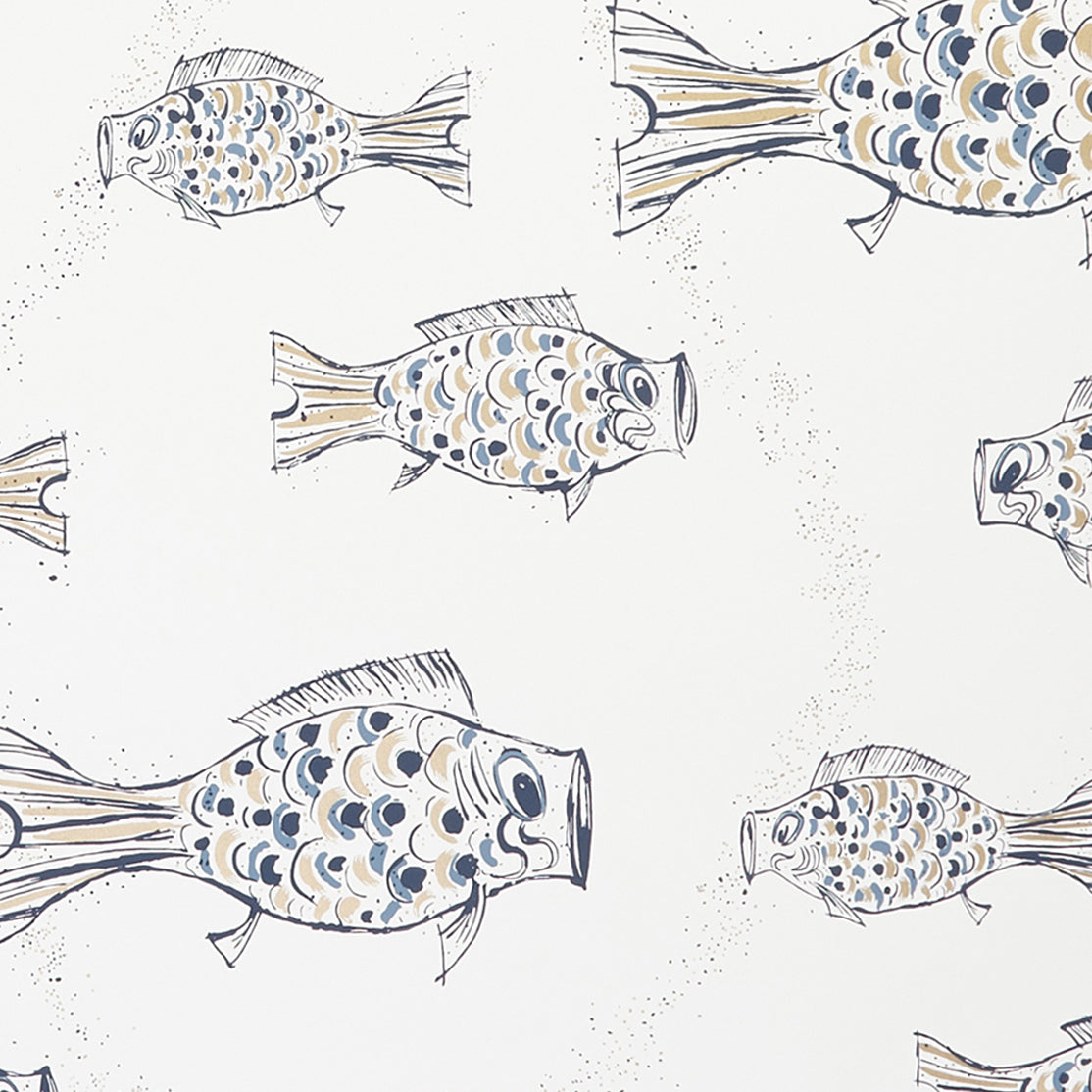 Close up of wallpaper with a pattern of hand-drawn fish in navy blue with tan and blue scales and scattered navy blue bubble dots on white. 