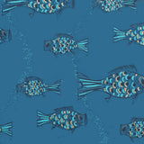 Close up of wallpaper with a pattern of hand-drawn fish in navy blue with tan and blue scales and scattered navy blue bubble dots on dark blue.