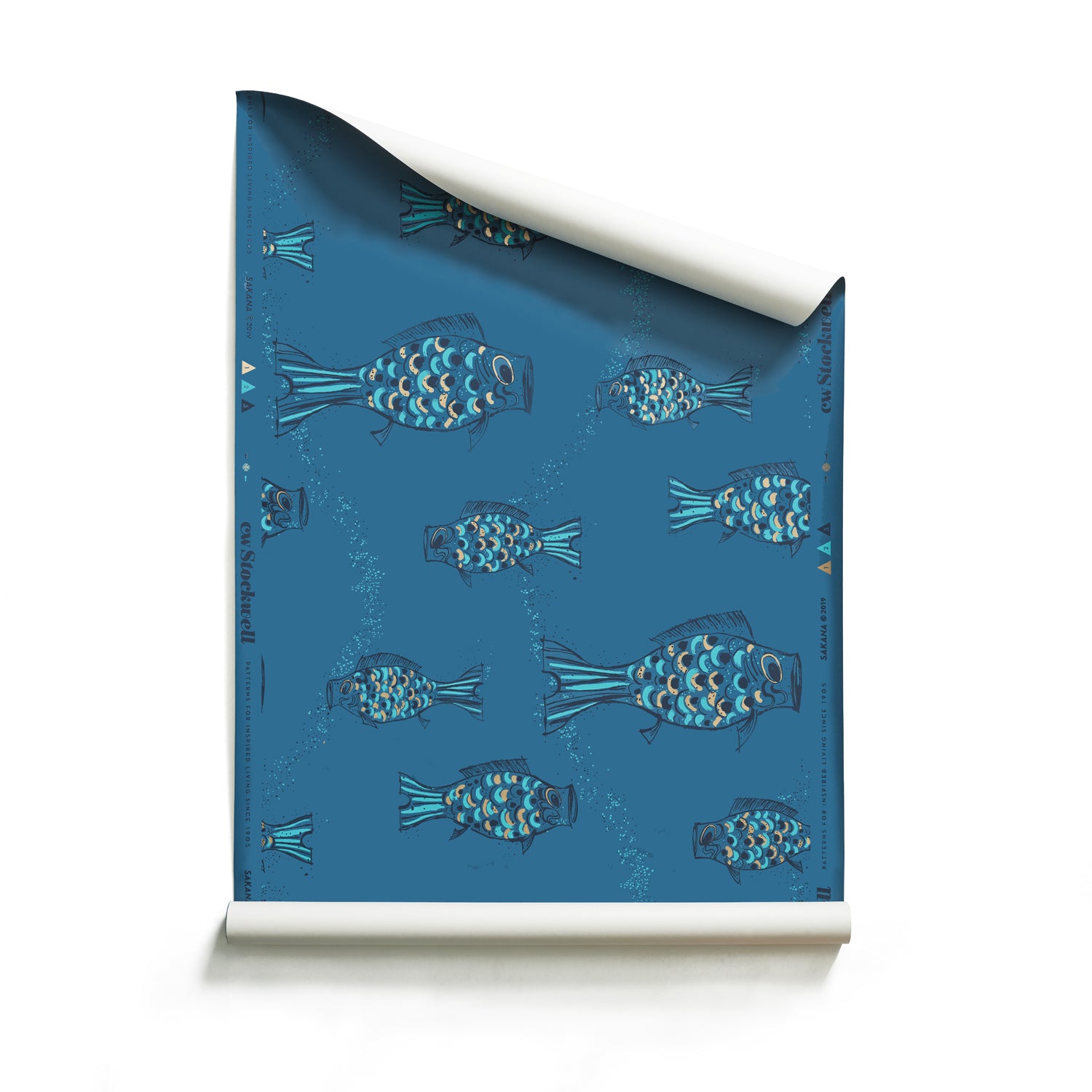 Roll of wallpaper with a pattern of hand-drawn fish in navy blue with tan and blue scales and scattered navy blue bubble dots on dark blue.