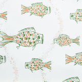 Close up of wallpaper with a pattern of hand-drawn fish in green with brown and orange scales and scattered bubble dots on white.