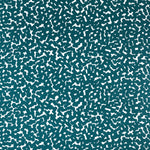 Detail of fabric in a playful polka dot print in turquoise on a white field.