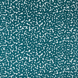 Detail of fabric in a playful polka dot print in turquoise on a white field.